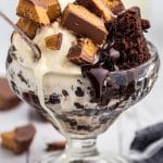 brownies with ice cream and reese's in a parfait glass