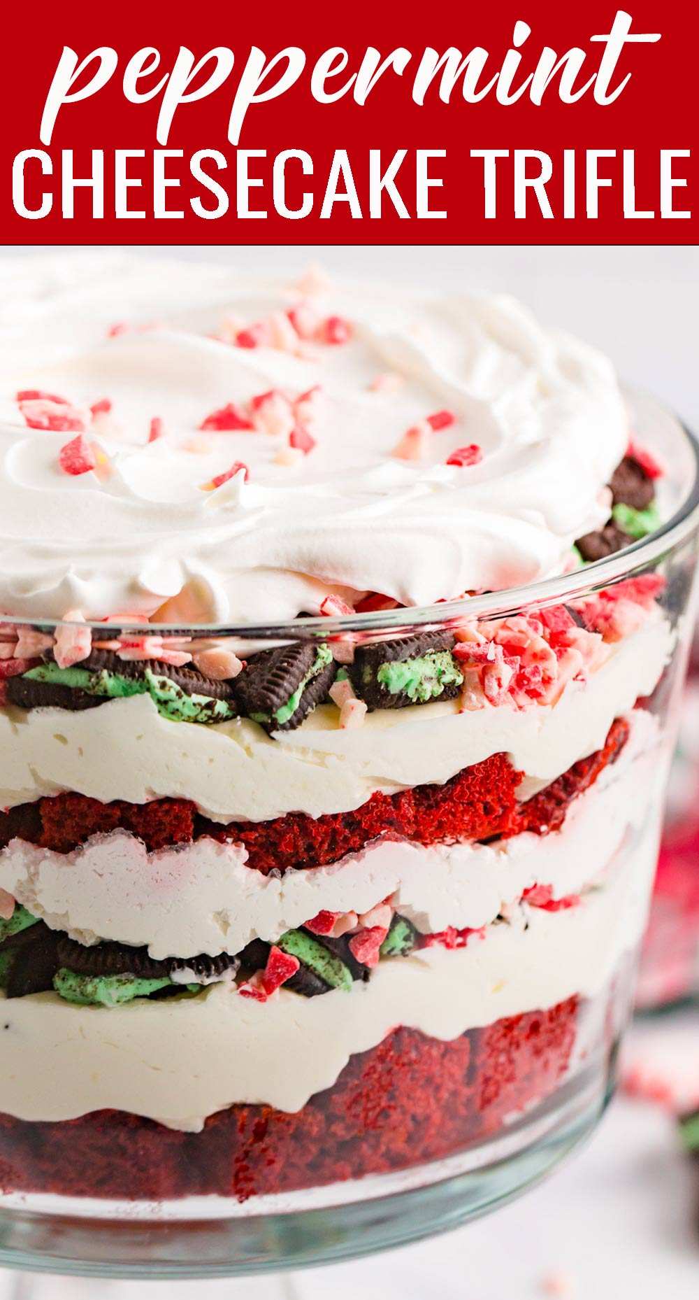Red velvet cake layered with peppermint cream cheese filling, mint Oreos, Cool Whip and peppermint crunch candies fills this peppermint cheesecake trifle. This festive, layered, holiday dessert will serve (and wow!) a crowd. via @tastesoflizzyt
