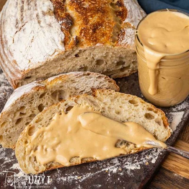 knife spreading peanut butter on bread