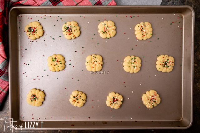 butter spritz cookies on a baking sheet