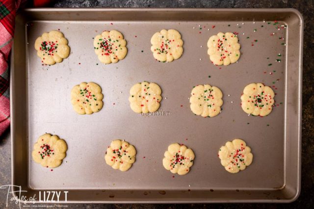 butter spritz cookies on a baking sheet