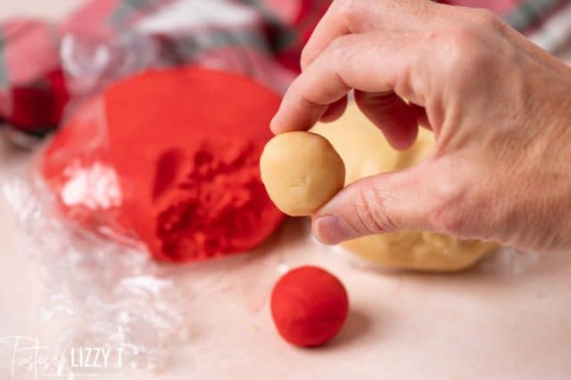 hand holding a cookie dough ball