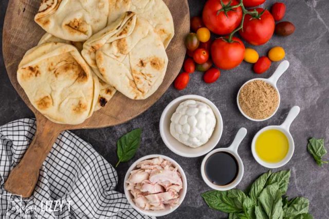 ingredients for chicken caprese pizzas on a table