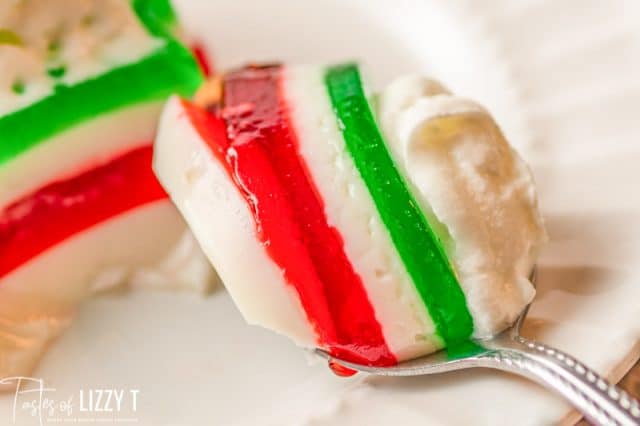 layered christmas jello bite on a fork