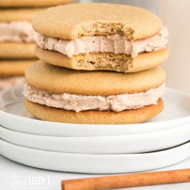 stack of cinnamon buttercream cookies with one bite out