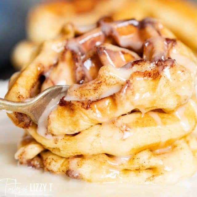 closeup of fork cutting a stack of waffles