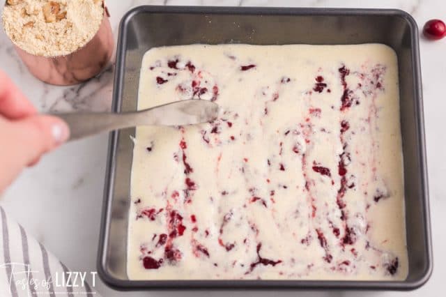 swirling cranberry sauce in a cream cheese