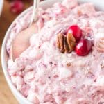 large bowl of cranberry fruit salad with a spoon