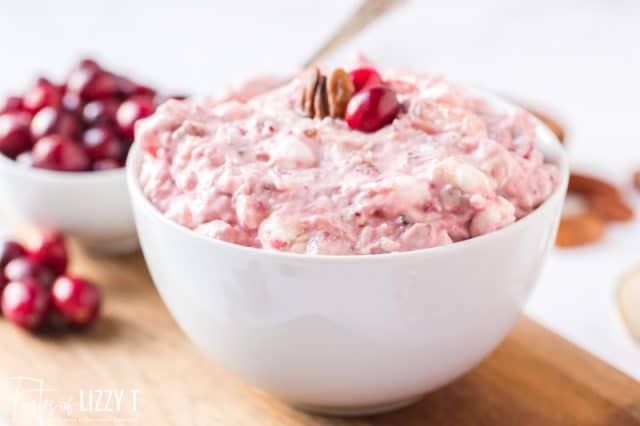 bowl of creamy cranberry salad on a wooden table