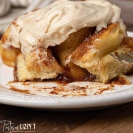 cinnamon roll on a plate with a bite out