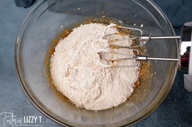 flour over molasses mixture in a mixing bowl