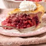 slice of cranberry pear pie on a plate with a fork