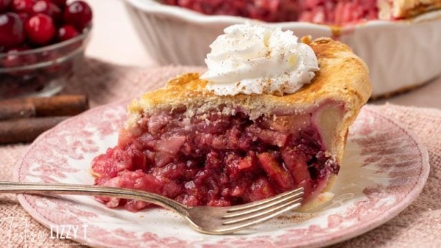 slice of cranberry pear pie on a plate with a fork