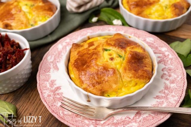egg souffle in a serving dish on a plate with a fork