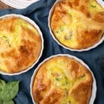 3 egg souffles on a table with bacon