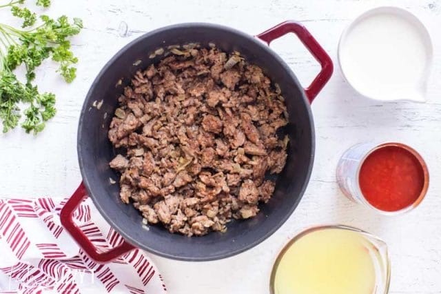 browned sausage in a dutch oven