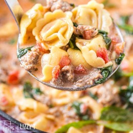 closeup of tortellini soup on a ladle