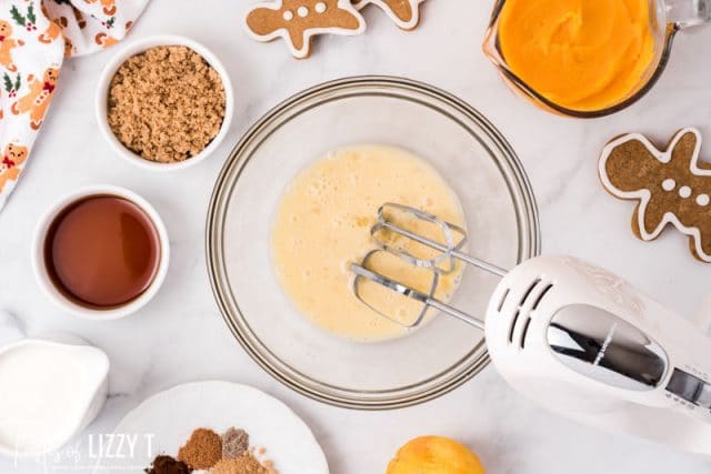 milk and eggs in a mixing bowl