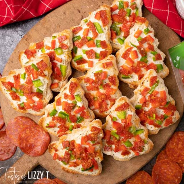 wooden board full of christmas tree pizzas