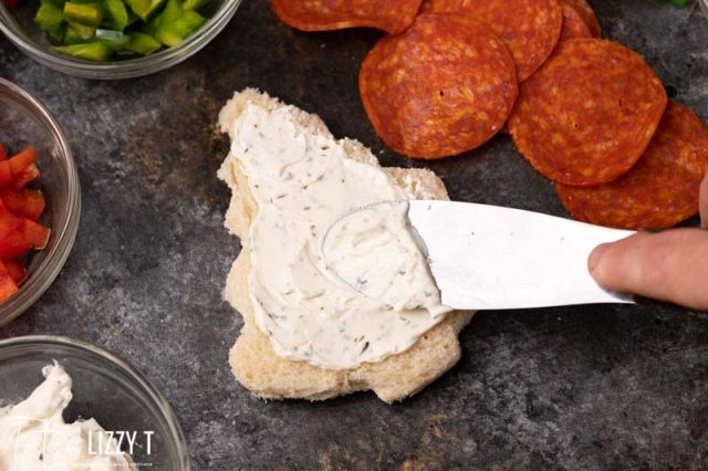 spreading cream cheese on a christmas tree cut out