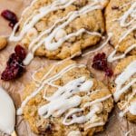 white chocolate drizzled cookies on parchment paper