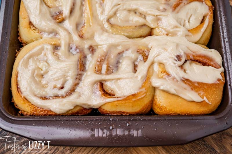 frosted cinnamon rolls in a baking pan