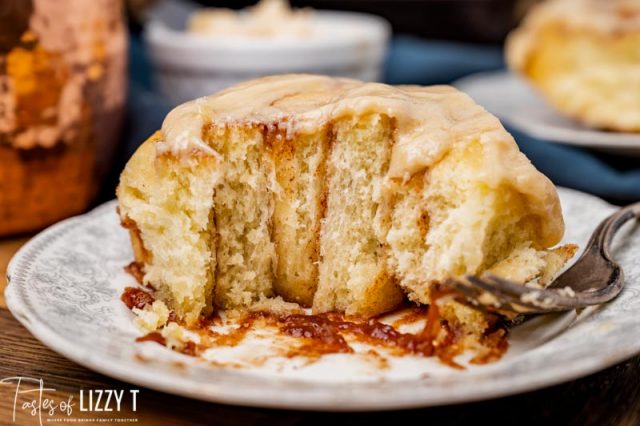 cinnamon roll on a plate that is half gone