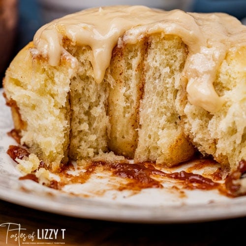 cinnamon roll on a plate that is half gone