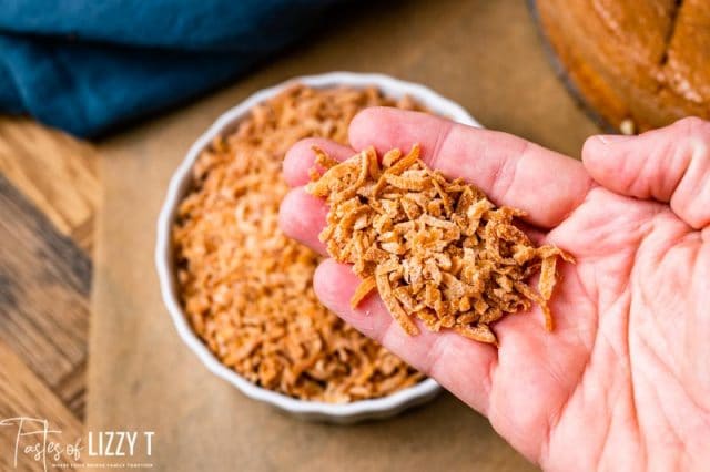 a hand holding toasted coconut