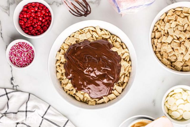 melted chocolate poured over rice cereal in a bowl