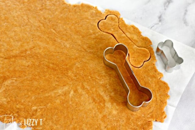 dog bone cookie cutter on rolled dough