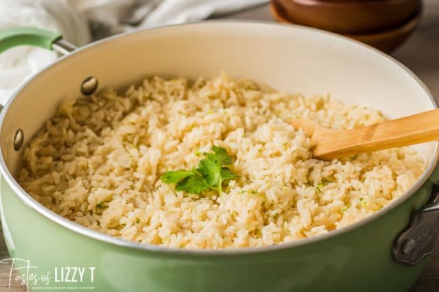 rice in a skillet with a wooden spoon