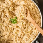 mexican white rice in a skillet with a spoon