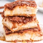 stack of three sopapilla cheesecake bars with honey