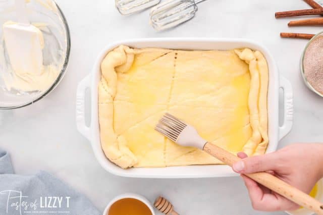 brushing butter on crescent rolls