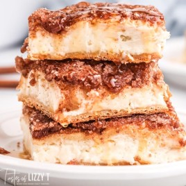 stack of three sopapilla cheesecake bars with honey on top