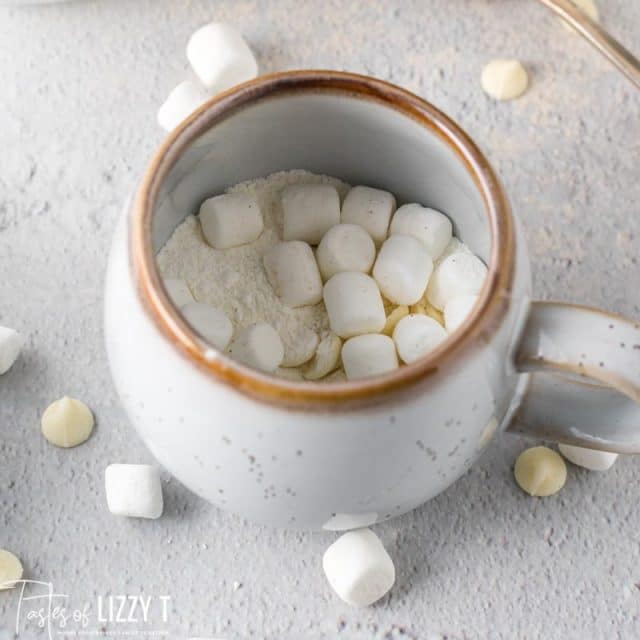 white hot chocolate powder and marshmallows in a mug