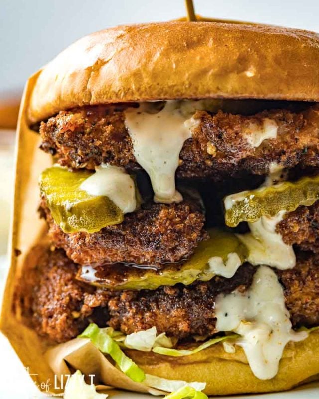 closeup of a spicy chicken sandwich with pickles and white sauce