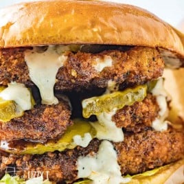 closeup of a spicy chicken sandwich with pickles