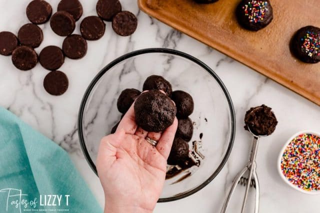 shaping cookie dough around a peppermint patty