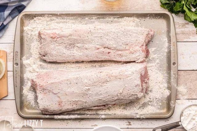 floured pork loin on a baking sheet