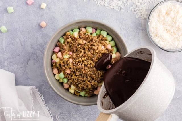 pouring chocolate over marshmallows and nuts