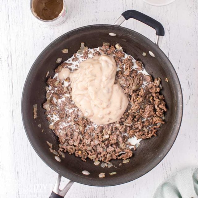 ground beef in a skillet with soup over it