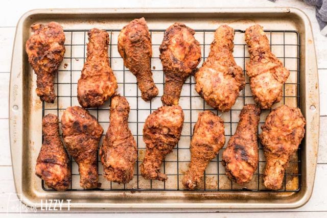 fried chicken drumsticks on a baking rack