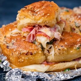 stack of pizza sliders with meat and cheese