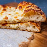 two slices of pizza with sourdough discard crust