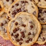 chocolate chip cookies piled on a wire rack