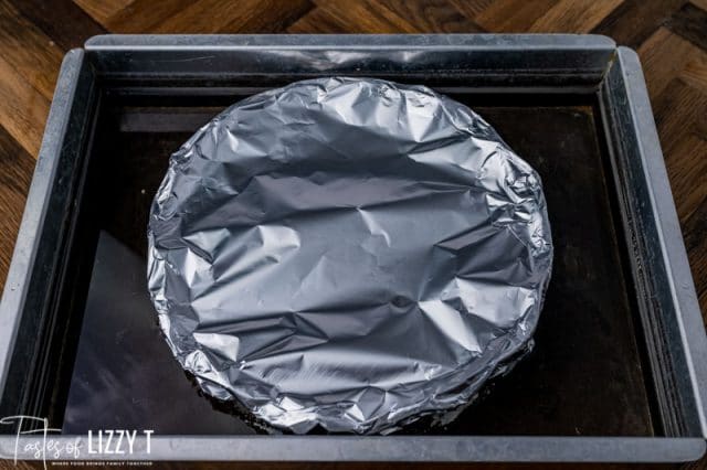 a pie plate covered in foil in a pan