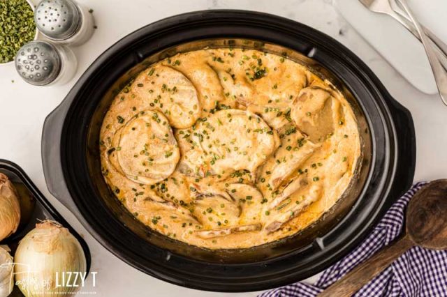 overhead shot of potatoes au gratin in a crockpot