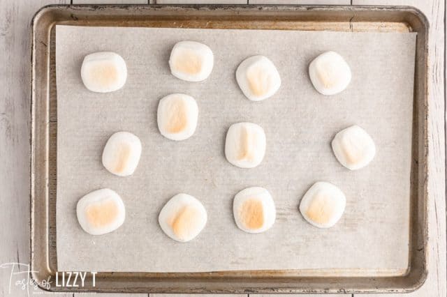 lightly browned marshmallows on a baking sheet